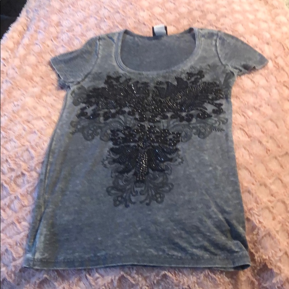 Gray t shirt with embellished design on front.